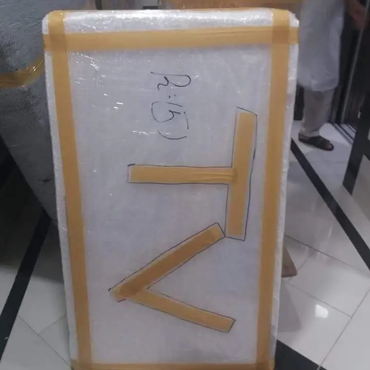 Television wrapped in protective film and tape and marked TV for moving
