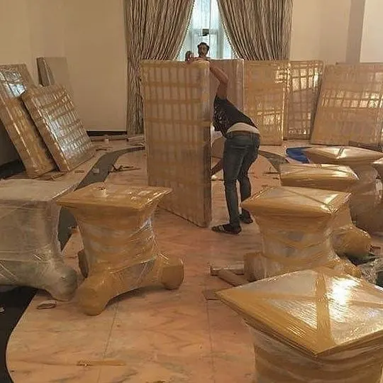Furniture wrapped in protective film and tape inside a villa before moving
